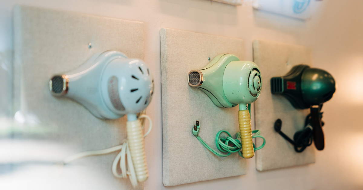 vintage hair dryers on a wall